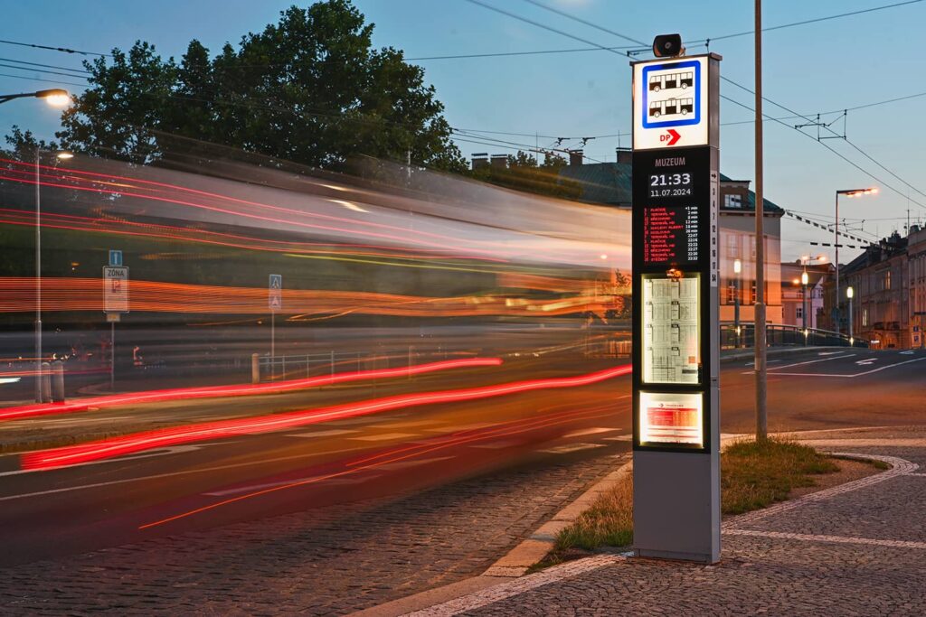 Evening photo of the lit sign at the public transport stop
