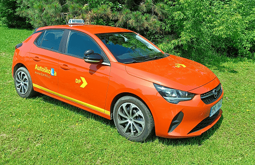Driving school vehicle - orange Opel on the lawn at the driving school
