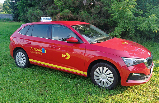 Driving school vehicle - red Scala on the lawn at the driving school