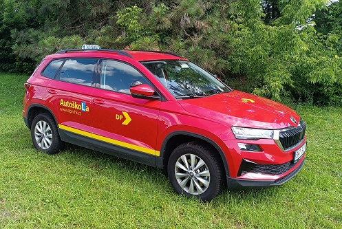 Driving school vehicle - red Karoq on the lawn at the driving school